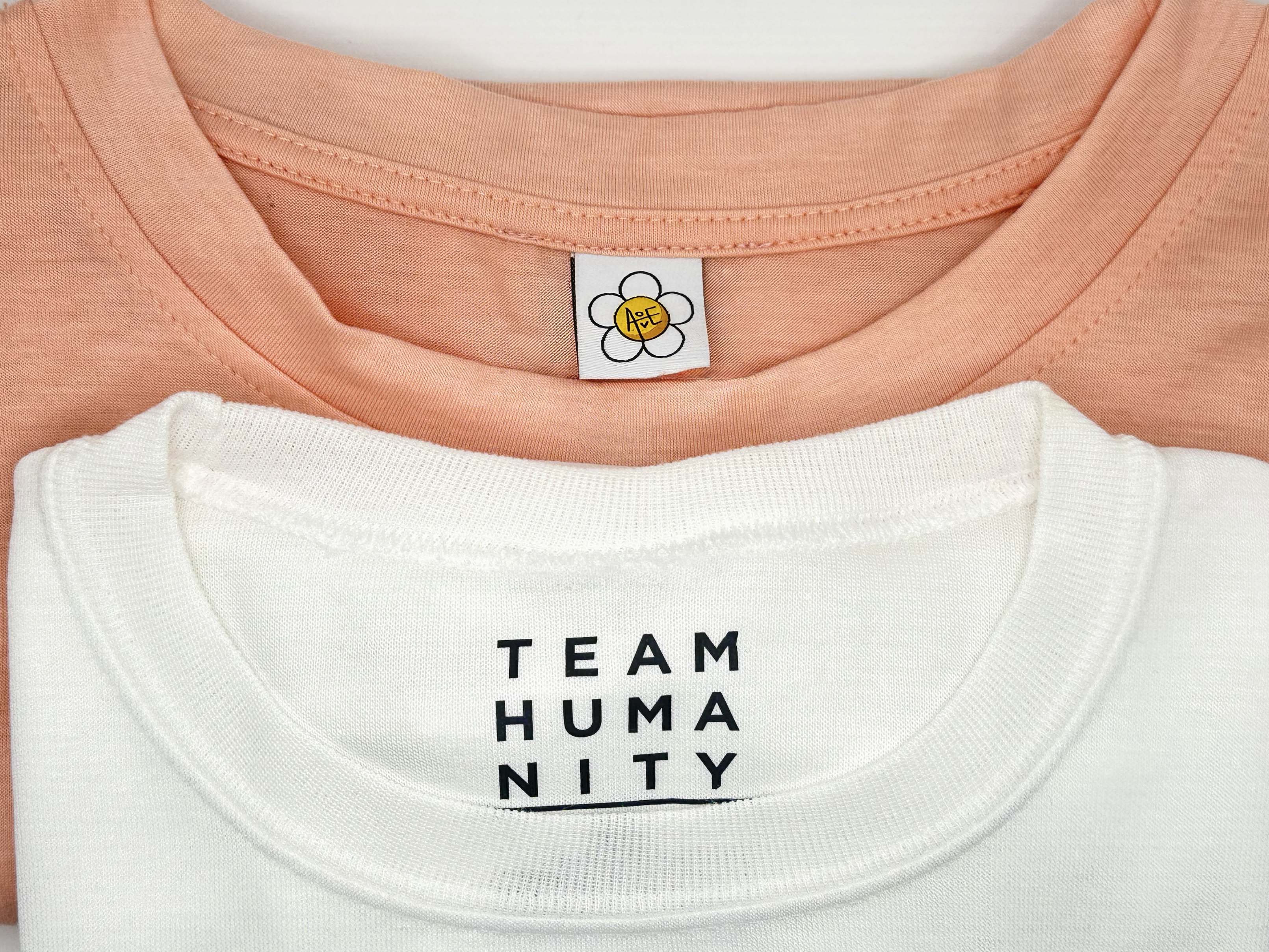 Side-by-side comparison of high-quality woven clothing label and budget Heat transfer label showing professional quality differences