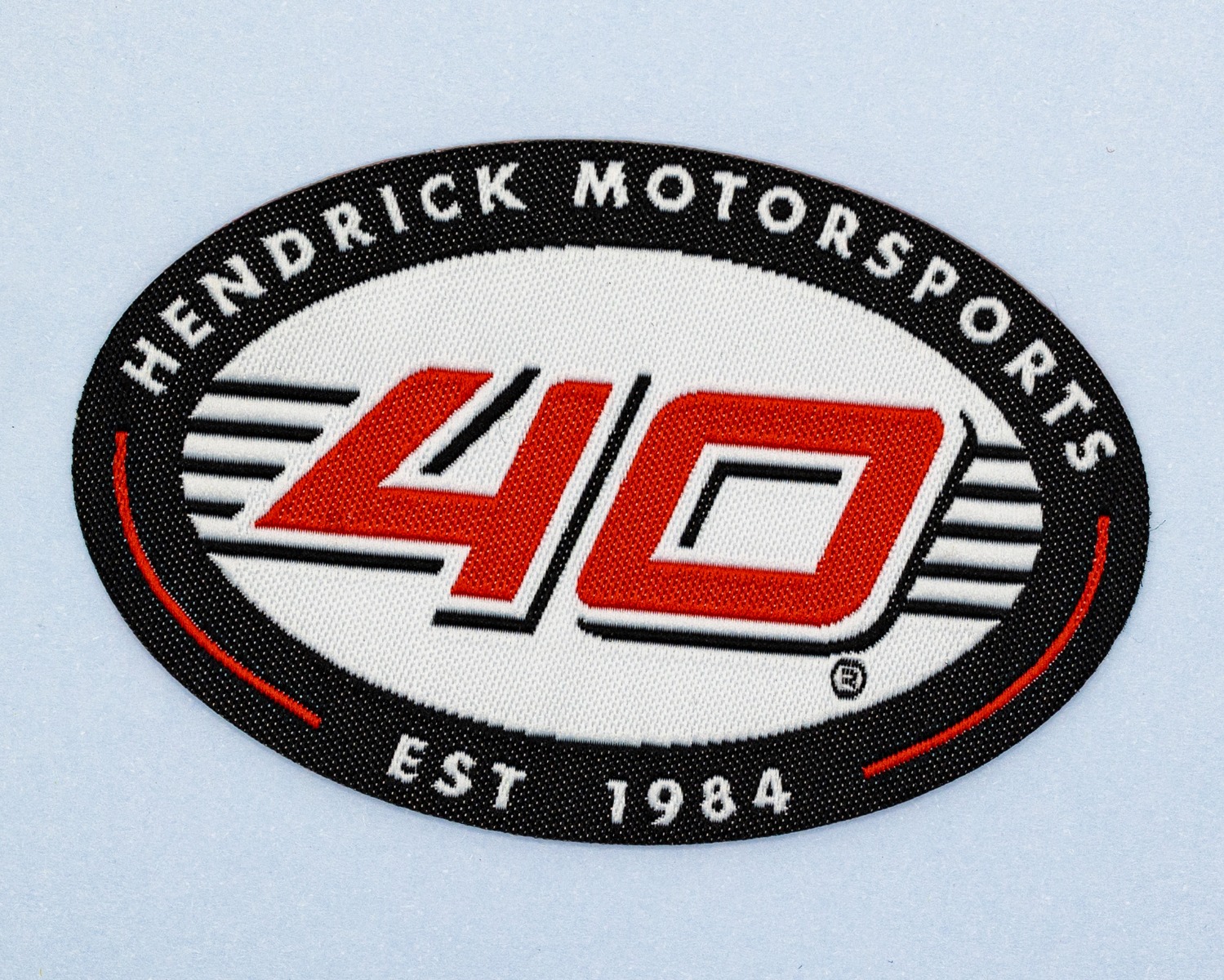 Close-up of woven patch surface showing fine detailed weave pattern with crisp text and lines