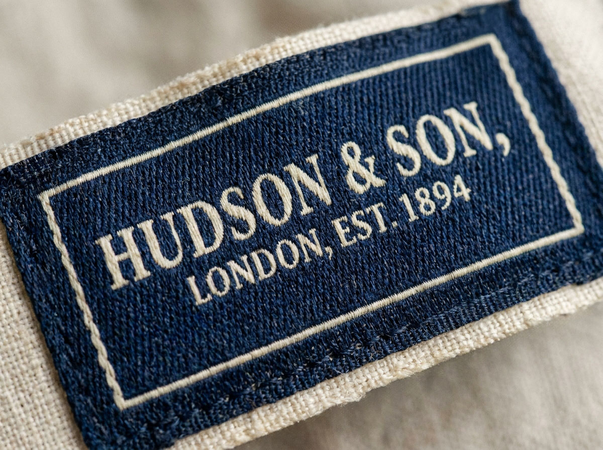 Close-up of retro clothing label showing woven thread texture and cotton backing
